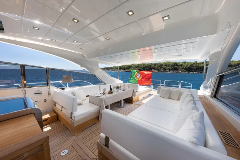  Yacht Photos Pics Luxurious 2006 Mangusta 80 yacht interior with elegant seating and Portuguese flag.