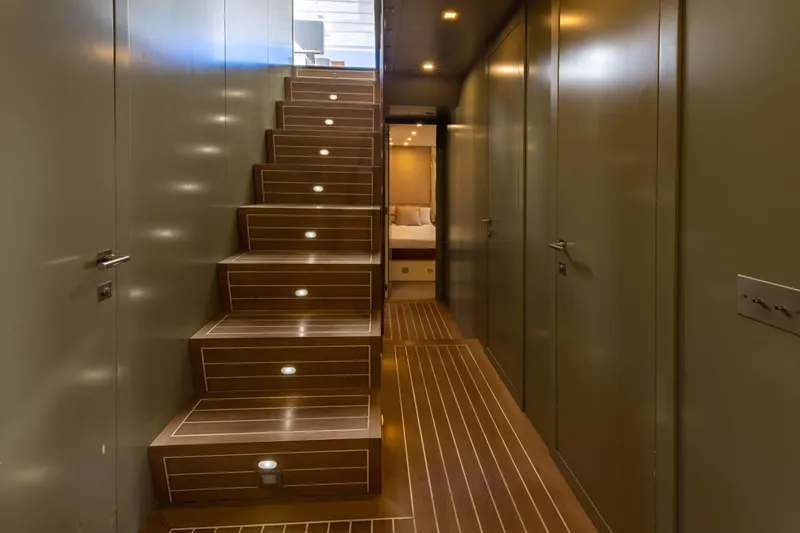  Yacht Photos Pics Luxurious interior of 2006 Mangusta 80 yacht with elegant wooden staircase and modern design.