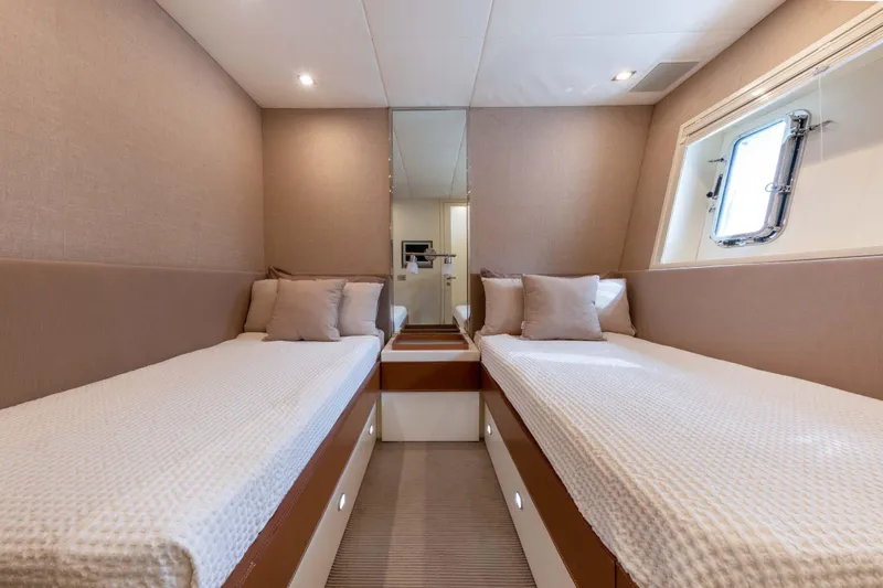  Yacht Photos Pics Luxurious twin cabin interior of 2006 Mangusta 80 yacht with modern decor.