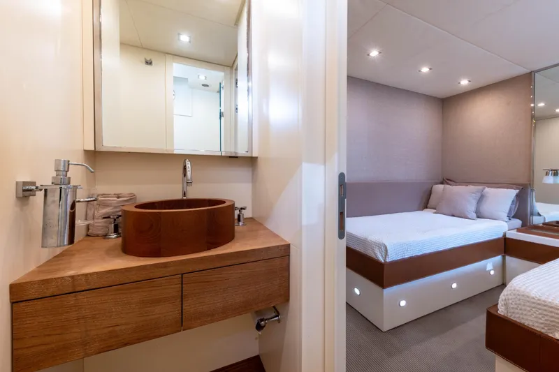  Yacht Photos Pics Luxurious 2006 Mangusta 80 yacht interior with modern bathroom and cozy bedroom.