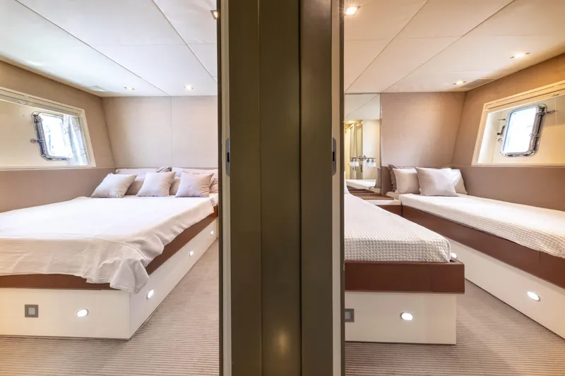  Yacht Photos Pics Luxurious 2006 Mangusta 80 yacht bedroom with twin beds and elegant decor.