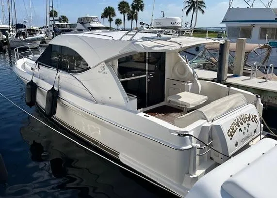 Yacht Photos Pics 2007 Riviera 3600 Sport Yacht docked at marina with palm trees in background.