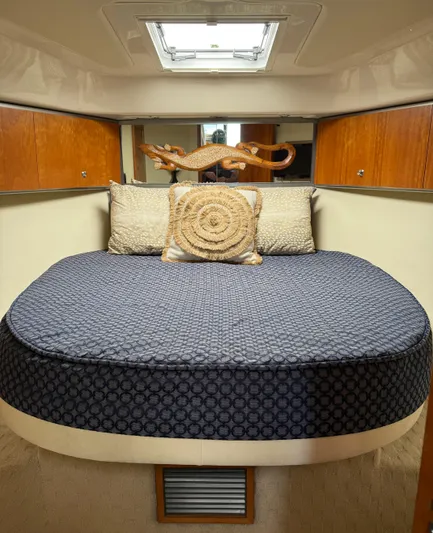  Yacht Photos Pics 2007 Riviera 3600 Sport Yacht cabin with cozy bed and decorative pillows.