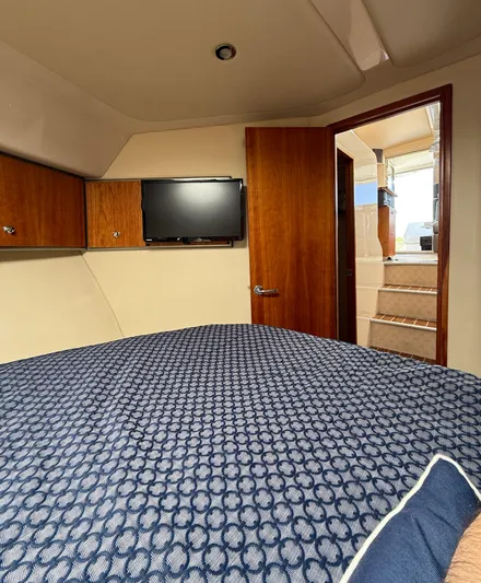  Yacht Photos Pics 2007 Riviera 3600 Sport Yacht cabin with bed, TV, and wooden interior.