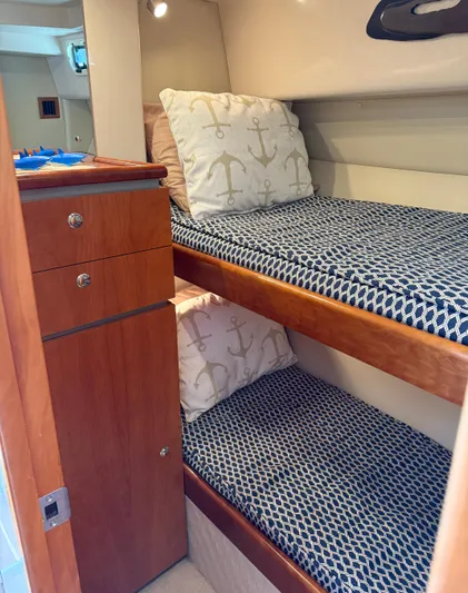  Yacht Photos Pics 2007 Riviera 3600 Sport Yacht cabin with bunk beds and nautical-themed pillows.