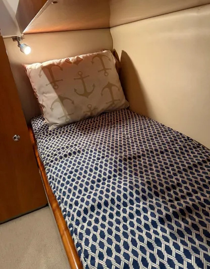  Yacht Photos Pics 2007 Riviera 3600 Sport Yacht cabin with patterned bedding and anchor-themed pillow.