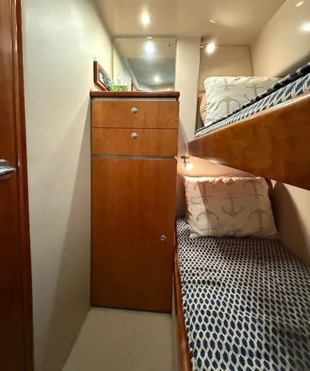  Yacht Photos Pics Interior of 2007 Riviera 3600 Sport Yacht with cozy bunk beds and wooden cabinetry.