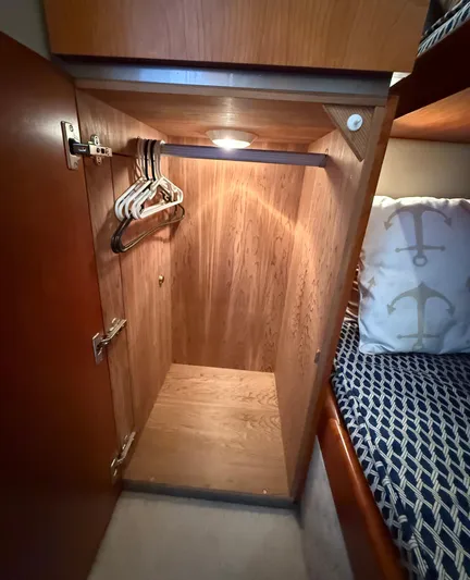  Yacht Photos Pics Wooden closet interior with hangers in a 2007 Riviera 3600 Sport Yacht cabin.