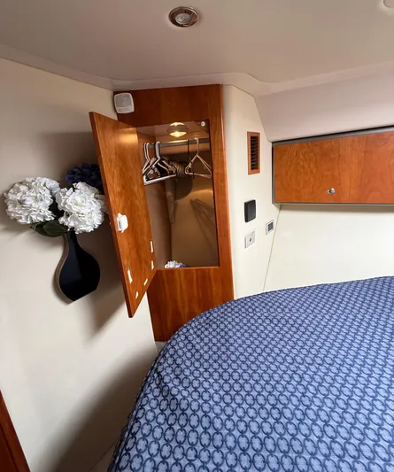  Yacht Photos Pics 2007 Riviera 3600 Sport Yacht cabin with closet, floral decor, and patterned bedding.