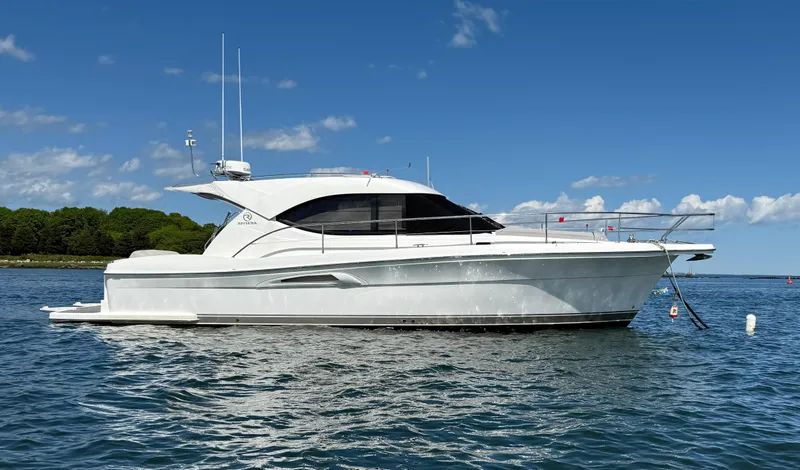  Yacht Photos Pics 2007 Riviera 3600 Sport Yacht on calm water under a clear blue sky.
