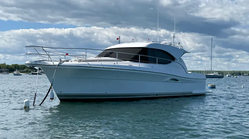  Yacht Photos Pics 2007 Riviera 3600 Sport Yacht on calm water under cloudy sky.