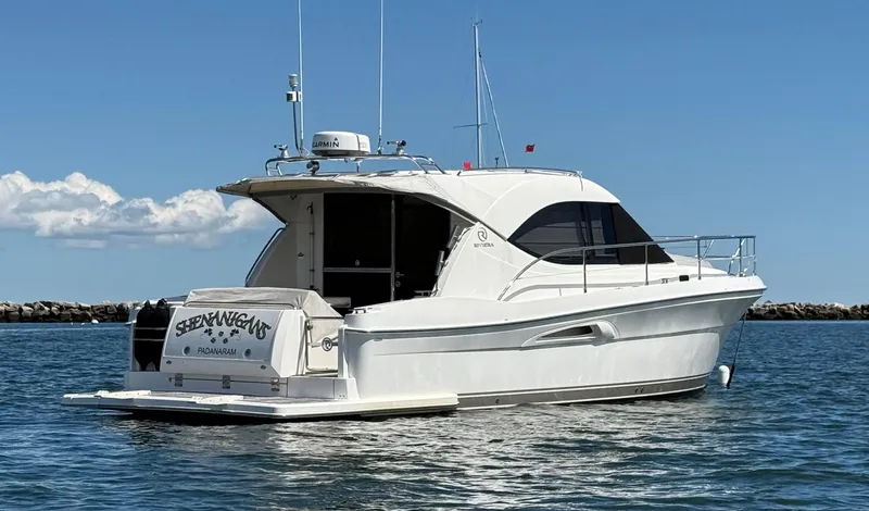  Yacht Photos Pics 2007 Riviera 3600 Sport Yacht on calm water under clear blue sky.