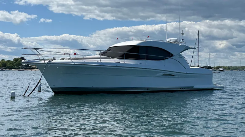  Yacht Photos Pics 2007 Riviera 3600 Sport Yacht on calm water under a partly cloudy sky.