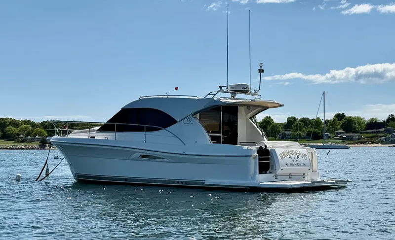  Yacht Photos Pics 2007 Riviera 3600 Sport Yacht on calm water, clear sky background.