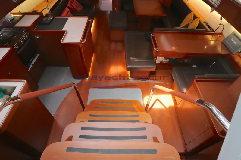  Yacht Photos Pics Interior of 2010 Beneteau Oceanis 58 yacht, featuring wooden cabinetry and seating area.