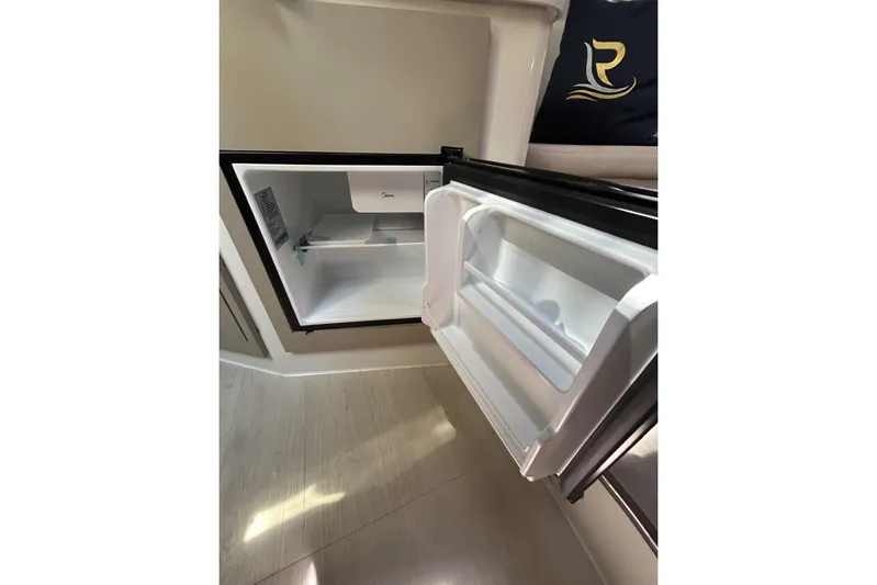  Yacht Photos Pics Open L'ACQUA LR350 refrigerator, 2025 model, with empty shelves and door compartments.