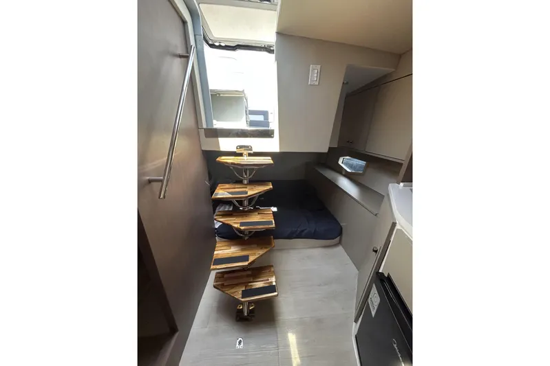  Yacht Photos Pics Modern L'ACQUA LR350 interior with spiral staircase and compact sleeping area, 2025 model.