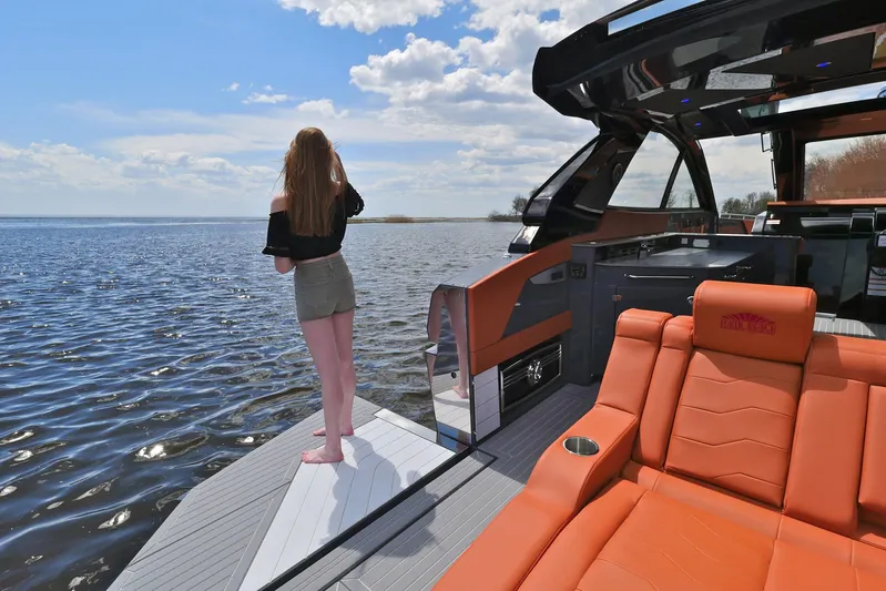  Yacht Photos Pics 2026 Cruisers Yachts 42 GLS I/O with woman enjoying scenic water view.