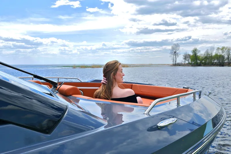  Yacht Photos Pics Woman relaxing on 2026 Cruisers Yachts 42 GLS I/O, enjoying serene lake view.