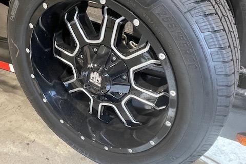 Black alloy wheel on a 2019 Statement 350 vehicle, featuring a modern, intricate design.