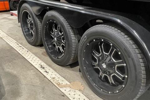 Triple black wheels on a 2019 Statement 350 vehicle in a garage.