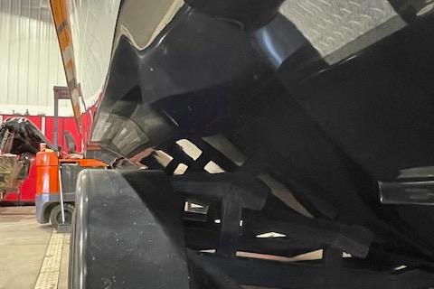 Close-up of a 2019 Statement 350 boat hull in a workshop setting.