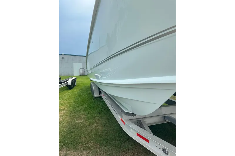 Cat Gone Willd Yacht Photos Pics 2023 Twin Vee 340 GFX CC boat on trailer, side view, outdoors.