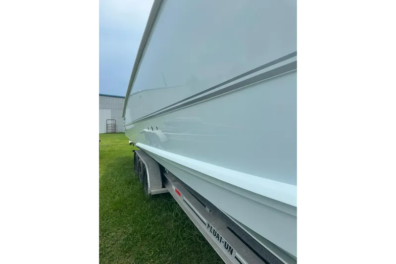 Cat Gone Willd Yacht Photos Pics 2023 Twin Vee 340 GFX CC boat on trailer, side view, outdoors.