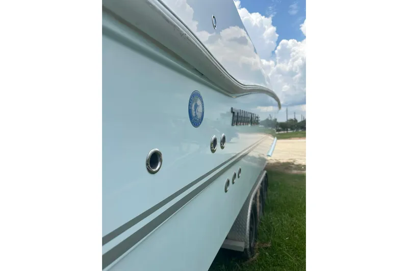 Cat Gone Willd Yacht Photos Pics 2023 Twin Vee 340 GFX CC boat side view with logo and sleek design.