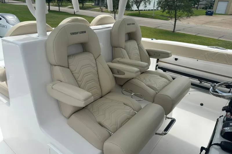 Cat Gone Willd Yacht Photos Pics 2023 Twin Vee 340 GFX CC boat with luxurious beige seating and armrests.
