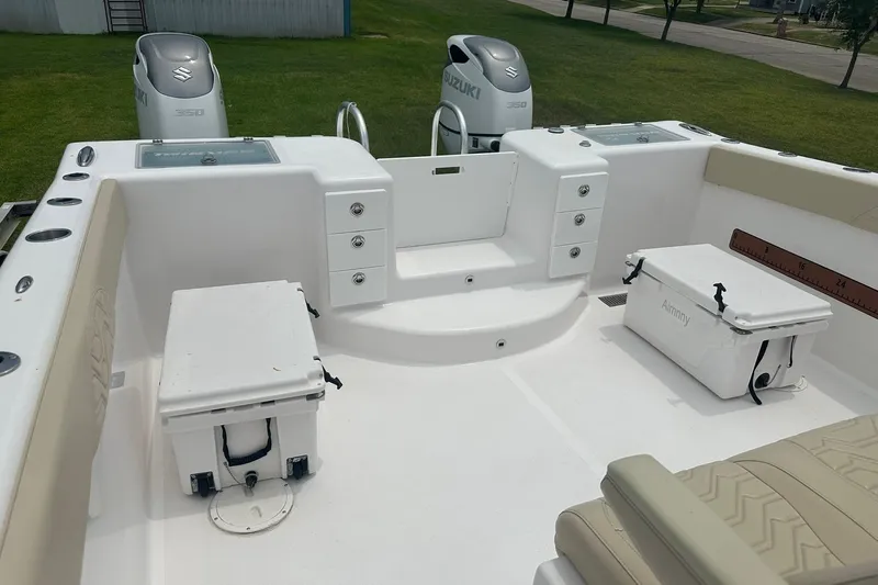 Cat Gone Willd Yacht Photos Pics 2023 Twin Vee 340 GFX CC boat deck with Suzuki engines and storage compartments.