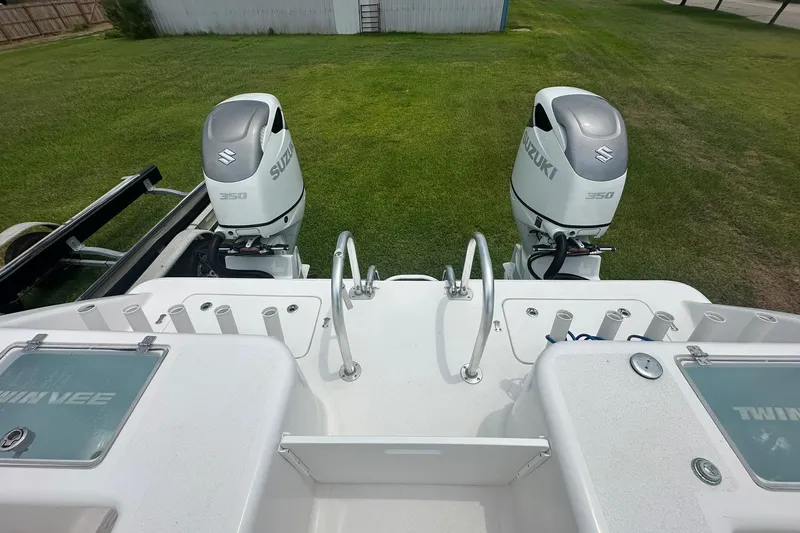 Cat Gone Willd Yacht Photos Pics 2023 Twin Vee 340 GFX CC boat with dual Suzuki 350 engines on grassy background.