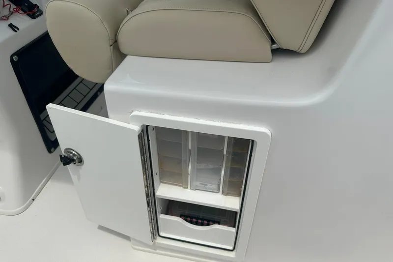 Cat Gone Willd Yacht Photos Pics 2023 Twin Vee 340 GFX CC boat storage compartment with open door and beige seating.