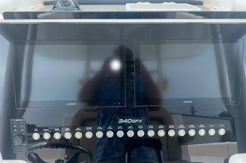 Cat Gone Willd Yacht Photos Pics 2023 Twin Vee 340 GFX CC dashboard with dual Garmin screens and control panel.