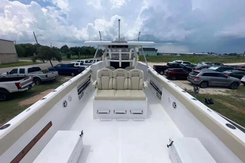 Cat Gone Willd Yacht Photos Pics 2023 Twin Vee 340 GFX CC boat with spacious deck and seating, parked outdoors.