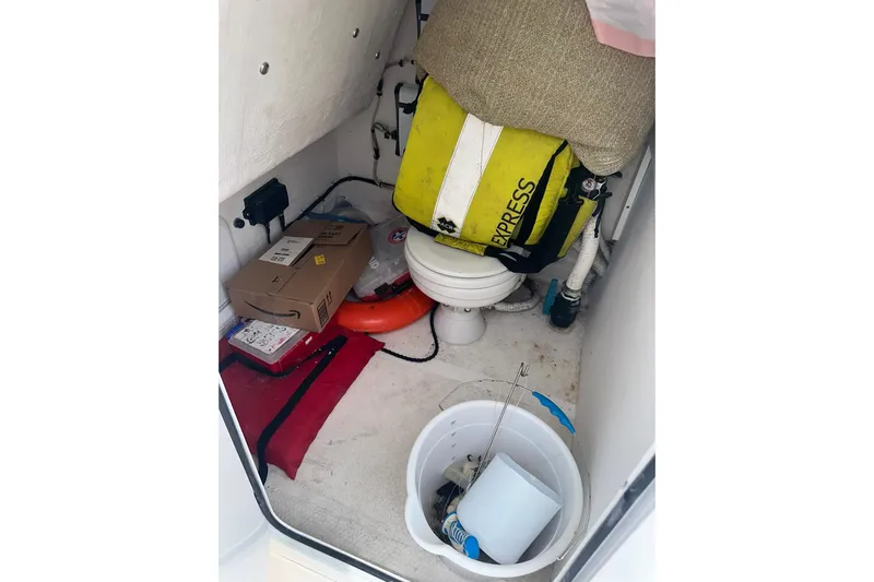Cat Gone Willd Yacht Photos Pics 2023 Twin Vee 340 GFX CC boat storage area with life jacket, bucket, and packages.