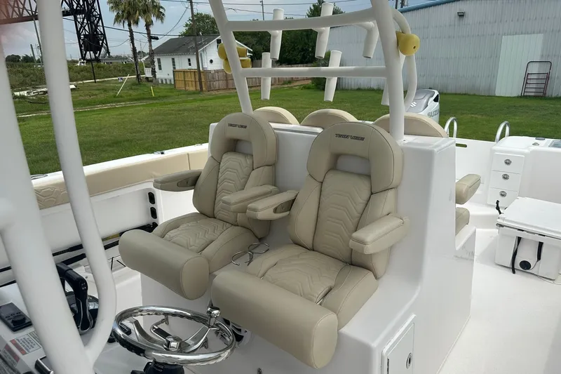Cat Gone Willd Yacht Photos Pics 2023 Twin Vee 340 GFX CC boat with luxurious beige seating and modern helm.