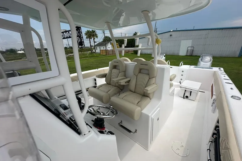 Cat Gone Willd Yacht Photos Pics 2023 Twin Vee 340 GFX CC boat interior with dual captain seats and steering console.