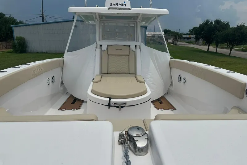 Cat Gone Willd Yacht Photos Pics 2023 Twin Vee 340 GFX CC boat interior with beige seating and Garmin equipment.