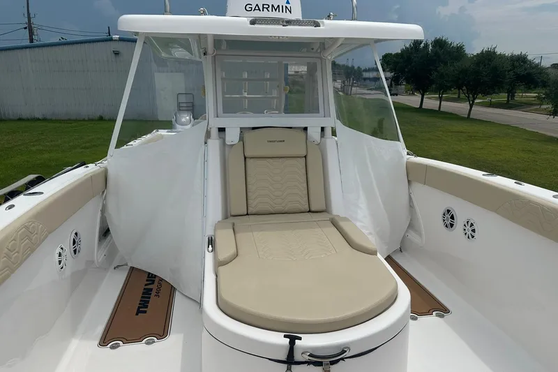 Cat Gone Willd Yacht Photos Pics 2023 Twin Vee 340 GFX CC boat interior with beige seating and Garmin equipment.