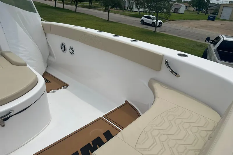 Cat Gone Willd Yacht Photos Pics 2023 Twin Vee 340 GFX CC boat interior with beige seating and cup holders.