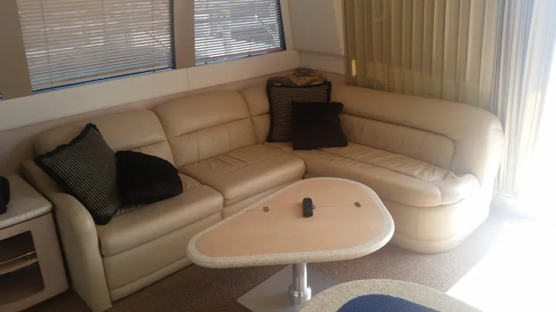 Trades Welcome Yacht Photos Pics 1999 Carver 530 Voyager Pilothouse interior with beige leather sofa and modern table.