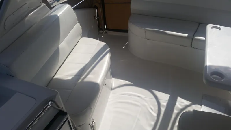 Trades Welcome Yacht Photos Pics 1999 Carver 530 Voyager Pilothouse interior seating area with white upholstery.