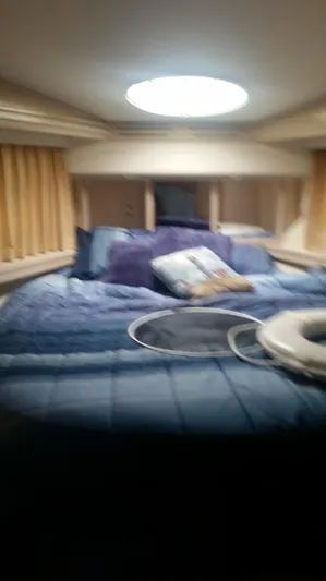 Trades Welcome Yacht Photos Pics Interior cabin of a 1999 Carver 530 Voyager Pilothouse yacht with a cozy bed.