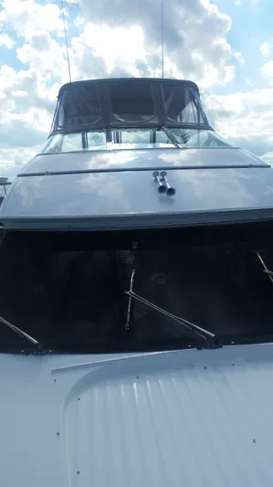 Trades Welcome Yacht Photos Pics 1999 Carver 530 Voyager Pilothouse yacht under a cloudy sky.