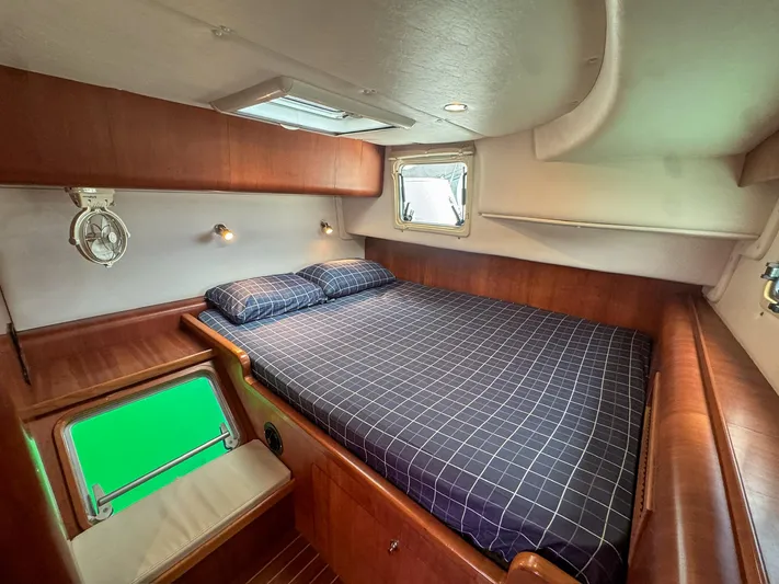 Adventure Yacht Photos Pics Luxurious cabin interior of 2013 Antares 44i yacht with cozy bed and wooden finish.