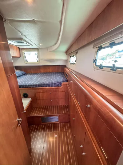 Adventure Yacht Photos Pics Interior of 2013 Antares 44i yacht with wooden cabinetry and cozy sleeping area.