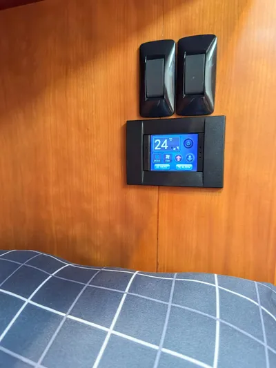 Adventure Yacht Photos Pics Control panel and switches on Antares 44i yacht, 2013 model, with checkered fabric in foreground.