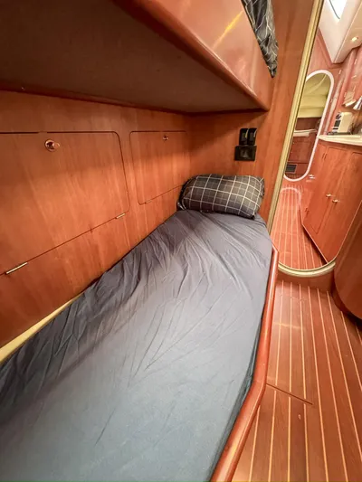 Adventure Yacht Photos Pics Cozy cabin interior of 2013 Antares 44i yacht with wooden finish and bedding.