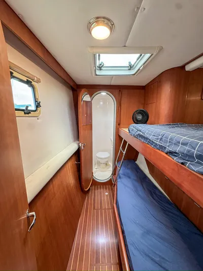 Adventure Yacht Photos Pics Interior of 2013 Antares 44i yacht with bunk beds and compact bathroom.